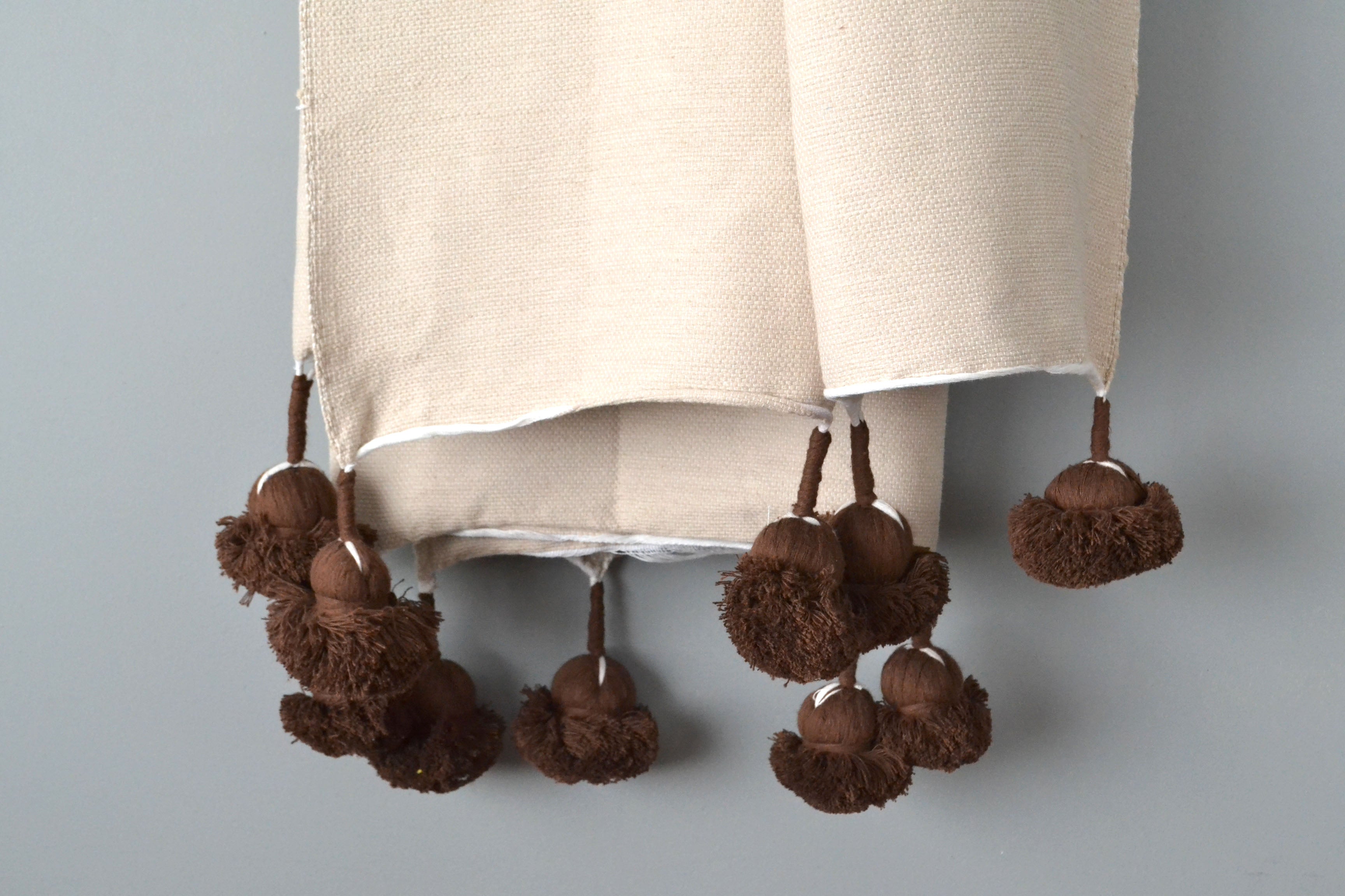 Natural Cotton Throw with Chocolate Brown Pom Poms from Yuba Mercantile