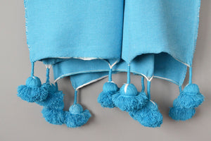 Blue Moroccan Cotton Pom Pom Throw Blanket from Yuba Mercantile