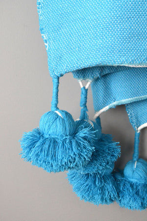 Blue Moroccan Cotton Pom Pom Throw Blanket from Yuba Mercantile