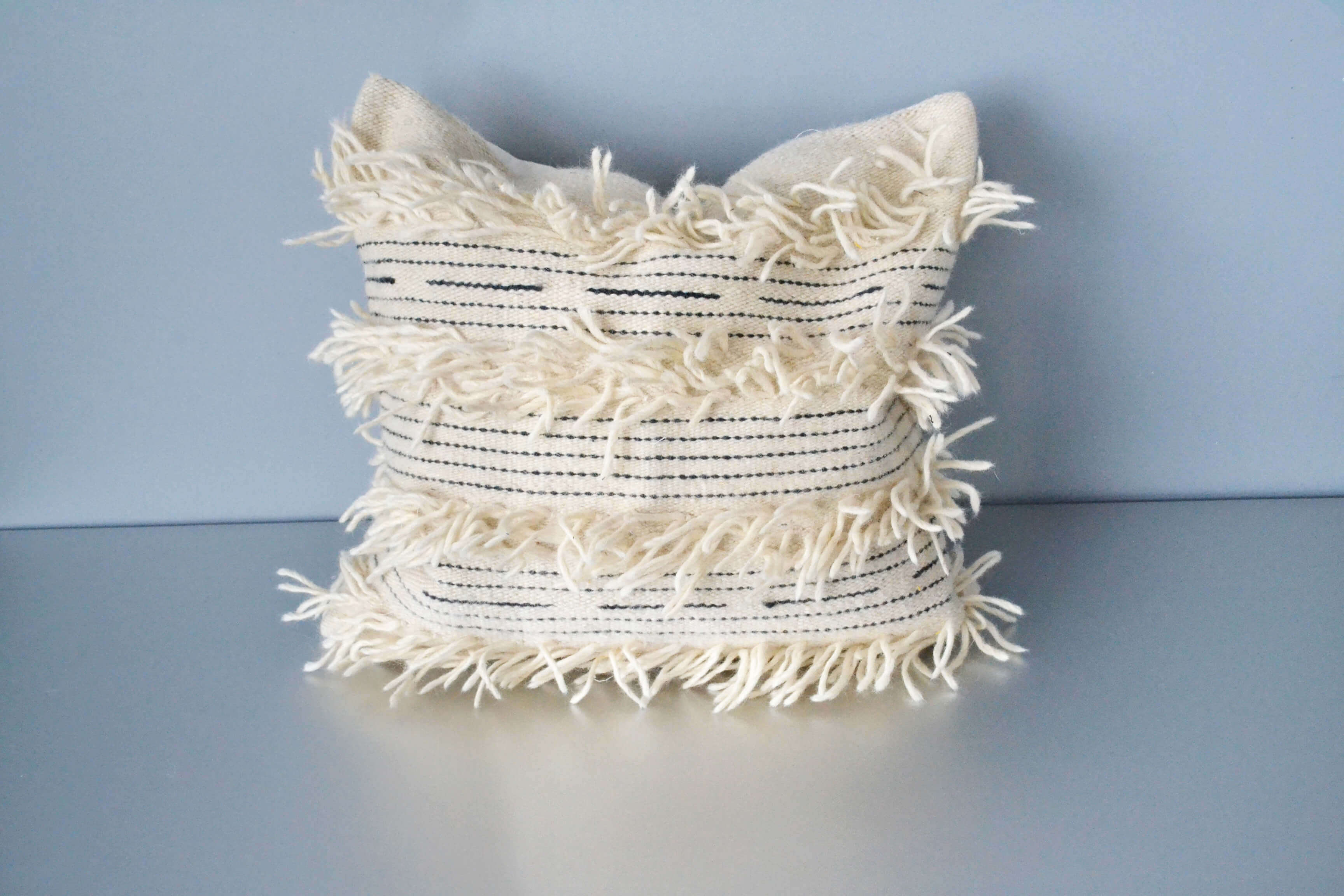 White fringe wool throw pillow by Yuba Mercantile